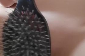 Naked shaved pussy is spanked with big hairbrush