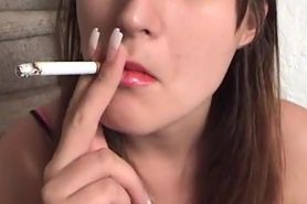 Sexy young brunette girl smoking up close