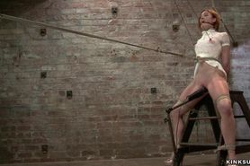 Redhead slave in pink knickers caned