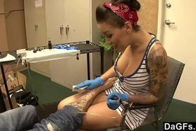 Beautiful tattoo artist satisfying a lucky client