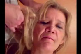 Blonde granny is taking a cumshot on her eyes