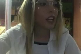 Beautiful blonde girl smoking in glasses