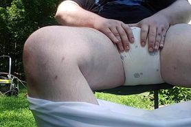Chubby diaperboy rubbing diaper outdoor