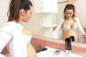 Missy pauses to admire her pregnant body in the bathroom mirror!