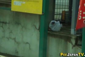 Asian fills cup with piss