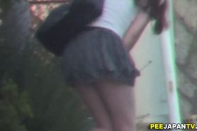 Asian babe pees crouching