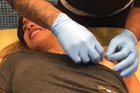 Girl getting her nipples pierced