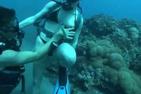 Snorkeling couple lick and screw underwater with scuba masks and scuba gear public sea underwater