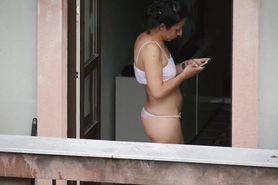 Candid girl in bra and thong showing ass on the balcony
