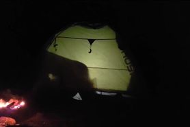Shadow sex in tent near camp fire
