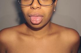 Sexy ebony in glasses playing with sexy mouth