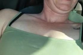 Sexy slut plays with pussy while driving around town