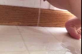Amateur girl pisses on bathroom floor