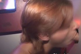Redheaded Amateur On Her Knees Giving Head Through A Hole