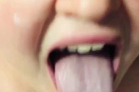 Girl holds out her long tongue for you covered in spit