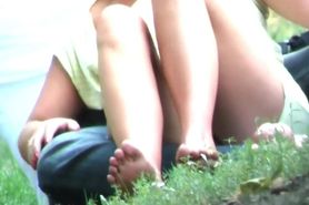 Blonde girl sitting upskirt in a park (no panties)