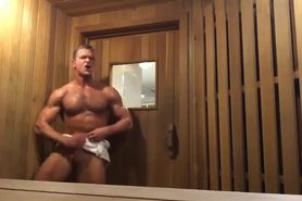 Muscle jock shoots load in public sauna