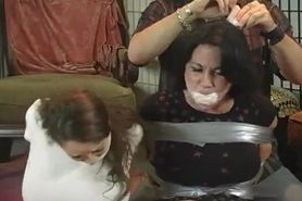 Two girls are wrap gagged and tormented