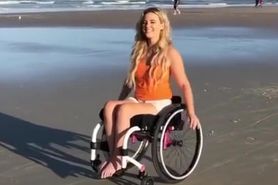 paraplegic wheeling on beach