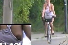 Hot woman exposing nipple while biking, preten ...
