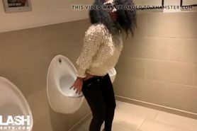Woman pissing in mens toilet