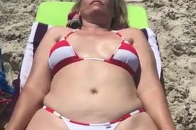 Milf paws wife tanning on the beach