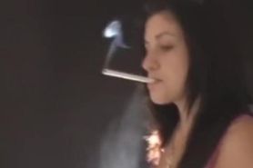 Sexy young brunette girl smoking & dangling