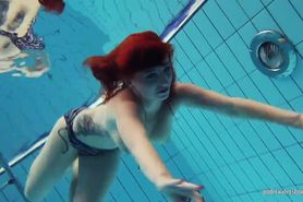 Redheaded Katrin is stripping underwater