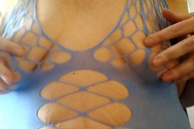 Playing with my rough nipples through blue fishnet feels so good.
