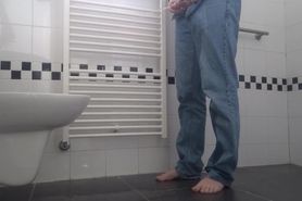 Desperate pee in bathroom, wetting pants and floor. End with cumshot