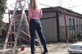 HOT MILF in tight jeans and sexy leotard, climbs the ladder in high heels, posing outdoor