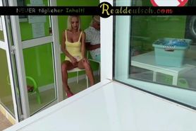 German blonde masturbates at a public laundry