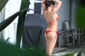 Big tit gf giving a handjob outside by the pool