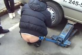 Girl changing tire buttcrack