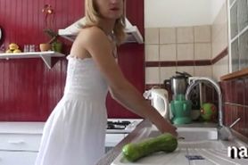 Blonde puts a large veg in her vag