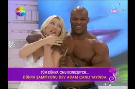 Sexy blonde turkish woman with big man on tv show