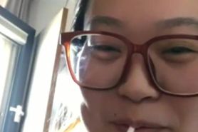 Chinese happy to finally light up her slim cigarette