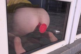 Anal orgasm by the window. Busty girl with a dildo fucks ass Doggystyle.