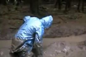BBW cougar rolls in mud wearing a pvc raincoat