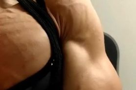 Ripped muscle girl flexing her chest and huge arms