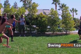 Swinger couples play a take clothes off game outside