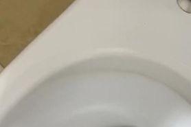 Big cock is full of urina and pisses it out in the public toilet