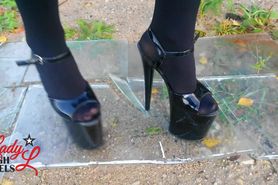 Lady L walking glas road with xtreme high heels.