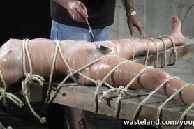 Bound naked slave gets covered with hot wax and given orgasms