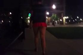 Exposing her ass in a short mini-skirt