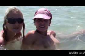 Three girls in swim suits taking a shower at the beach - video 2