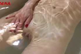 The horny whore masturbates and pees in the tub with water
