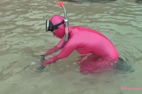 Veronica snorkelling on the beach in pink latex