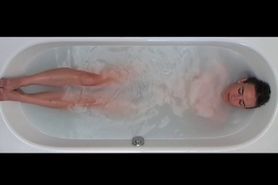 Naked and relaxed woman in the bathtub