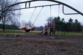 Young Lady naked in public Park on Swing